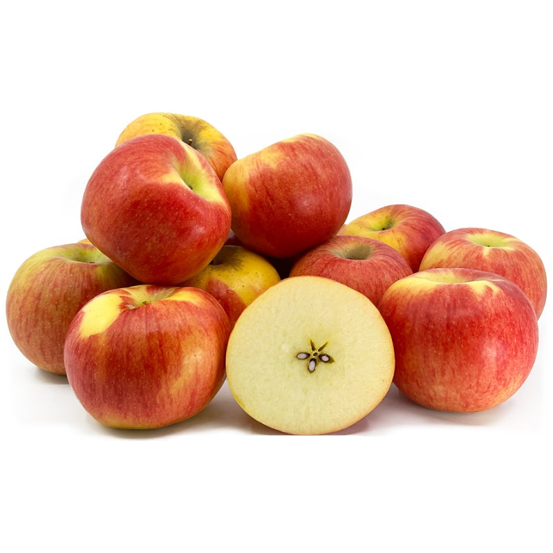Apples with a focus on one cut in half on a white background