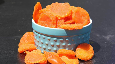 Dried Apricots: A Bowl of Nutrient-Rich, Sun-Dried Apricots on a Wooden Table