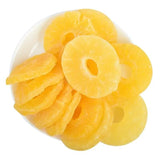 "Close-up of dried pineapple rings, showcasing their vibrant yellow color and natural, wrinkled texture."