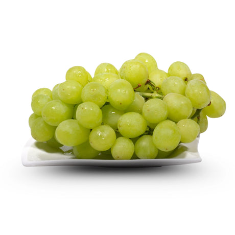 Bunch of green grapes on a white plate with a white background
