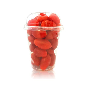 Clear plastic container filled with red tomatoes on a white background