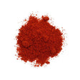 "Hot Paprika Powder in a small ceramic bowl with fresh red chili peppers in the white background."