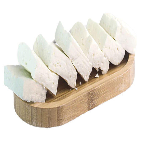 Fresh Syrian Nabulsi Cheese Low Salt, 250g  on a wooden cutting board, showcasing its creamy texture and traditional appearance.